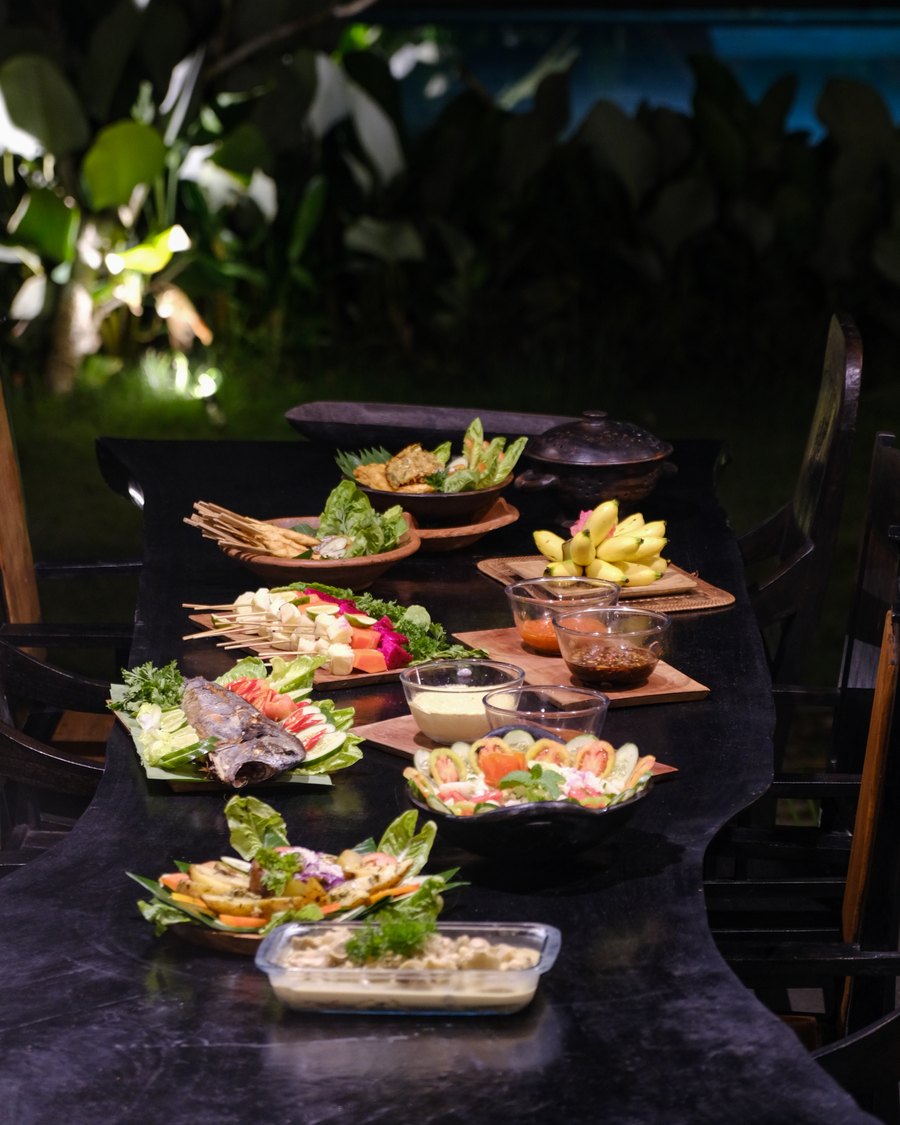 shared plates on banana leaves at night