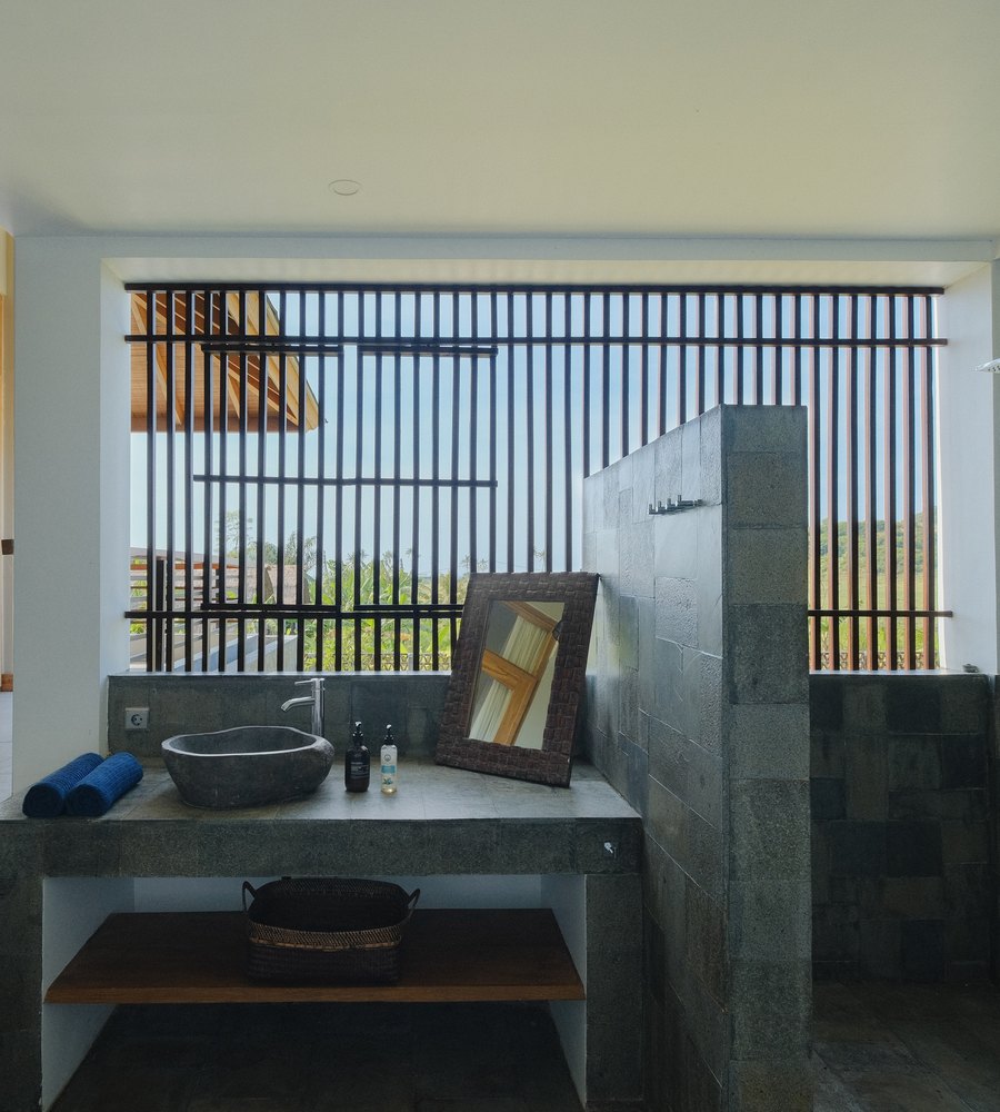 a bathroom with a slatted window